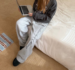 Printed fleece cuffed sweatpants in gray, seated
