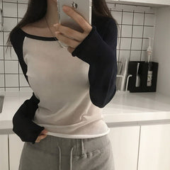 Color-block knit sweater top in black white, styled