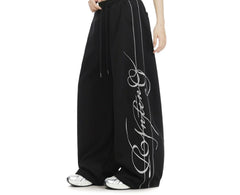 Embroidered wide-leg sweatpants in black, side view