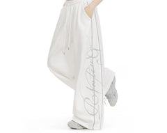 Embroidered wide-leg sweatpants in white, side view