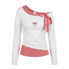 White long-sleeve top with red and white checkered details on a white background