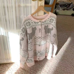 Knitted sweater with dog pattern on a hanger in a room.