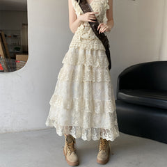Person wearing a white lace dress with beige boots in an indoor setting.
