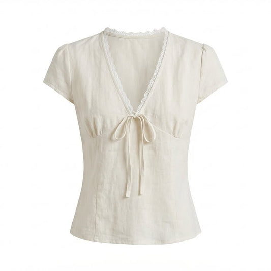 Beige top with a V-neck and tie detail on a white background