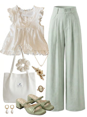 Fashion outfit with a top, pants, bag, and accessories on a white background