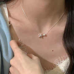 Necklace with a pendant worn by a person, close-up of the necklace on the neck.