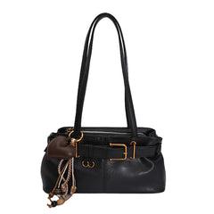 Black handbag with gold accents on a white background