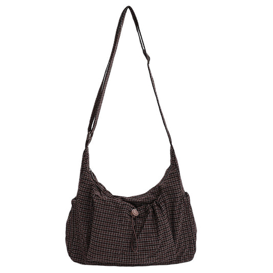Brown checkered shoulder bag on a white background