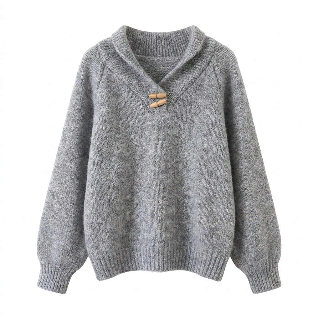Gray knitted sweater with a wooden button on a white background