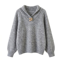 Gray knitted sweater with a wooden button on a white background