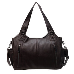 Black handbag with multiple pockets and straps on a white background