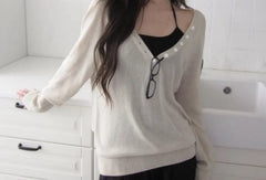 V-neck button knit top in Off-white, styled with glasses