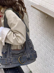 Retro washed denim shoulder bag in denim blue, worn seated