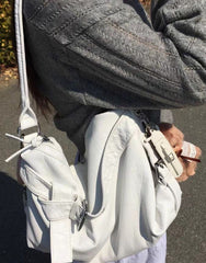Vintage motorbike leather shoulder bag in White, worn on the shoulder