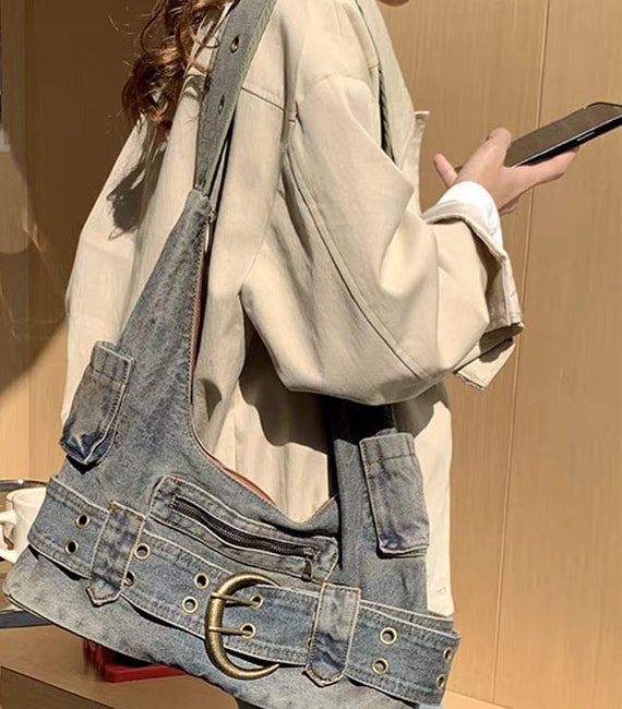 Retro washed denim shoulder bag in denim blue, worn on the shoulder, side view