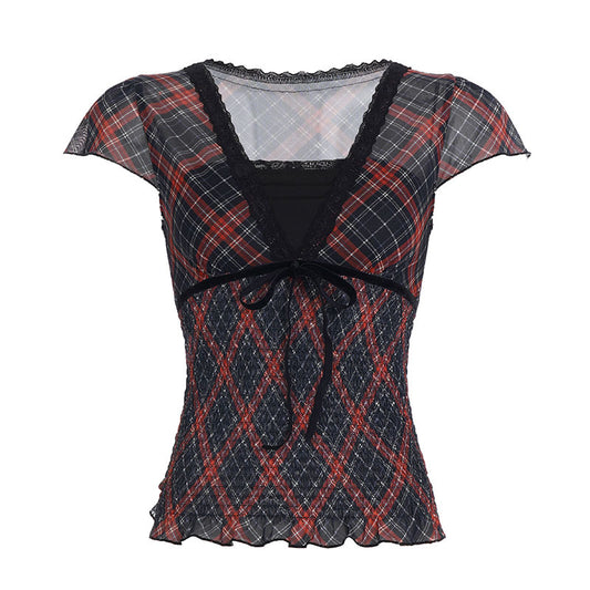 Plaid patterned top with sheer overlay on a white background