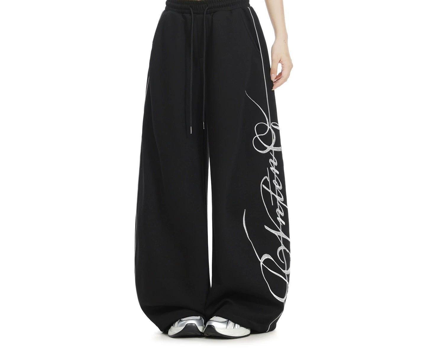 Embroidered wide-leg sweatpants in black, front view