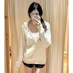 Women's hooded cable knit pullover with zipper opening