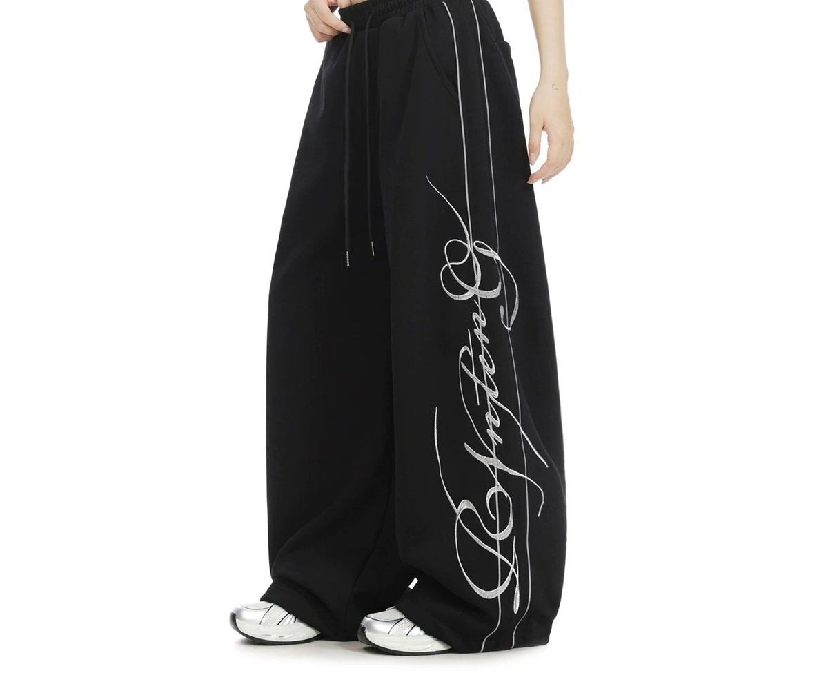 Embroidered wide-leg sweatpants in black, side view