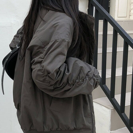 Stand-up collar pleated pilot sleeve padded jacket in dark gray, back view with pleated sleeve