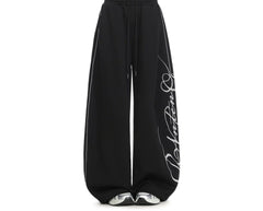Embroidered wide-leg sweatpants in black, drawstring waist