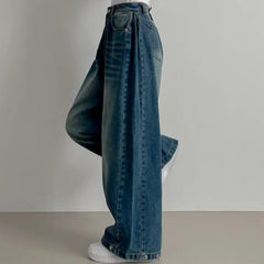 Vintage washed wide-leg jeans in dark blue, side view with ankle buttons
