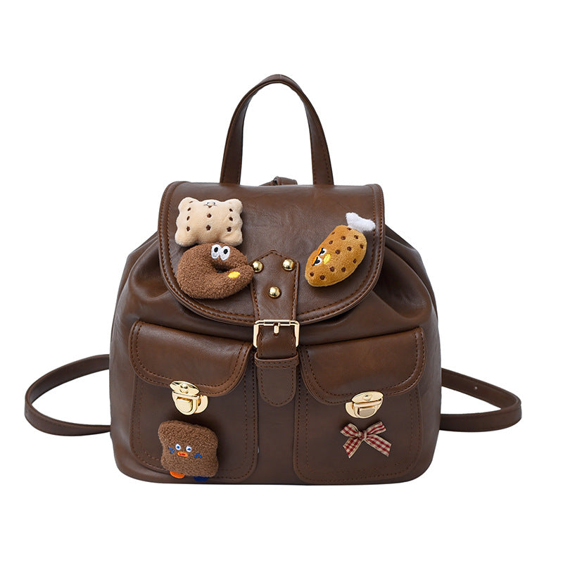 Brown backpack with cartoon character patches on a white background