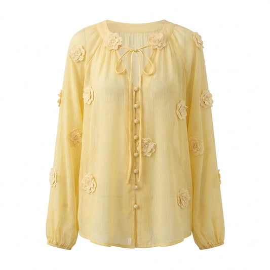 Yellow blouse with floral embellishments on a white background