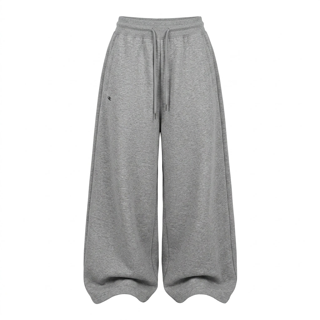 A pair of wide-leg, relaxed-fit sweatpants in heather gray, featuring an elastic waistband and a matching drawstring, shown against a plain white background.
