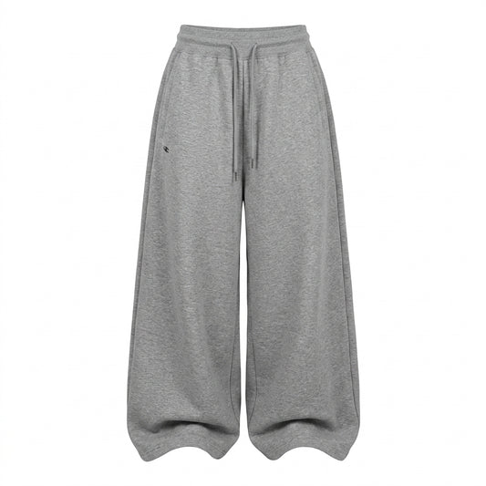A pair of wide-leg, relaxed-fit sweatpants in heather gray, featuring an elastic waistband and a matching drawstring, shown against a plain white background.