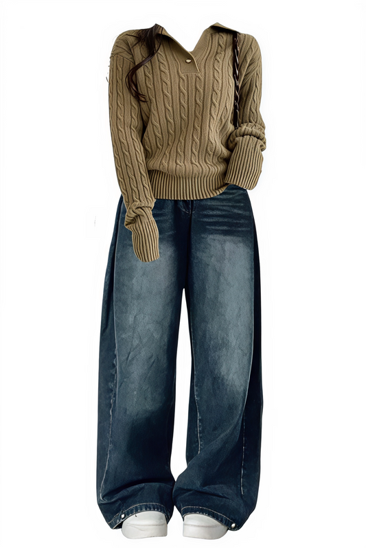 Brown cable knit sweater and blue jeans on a white background
