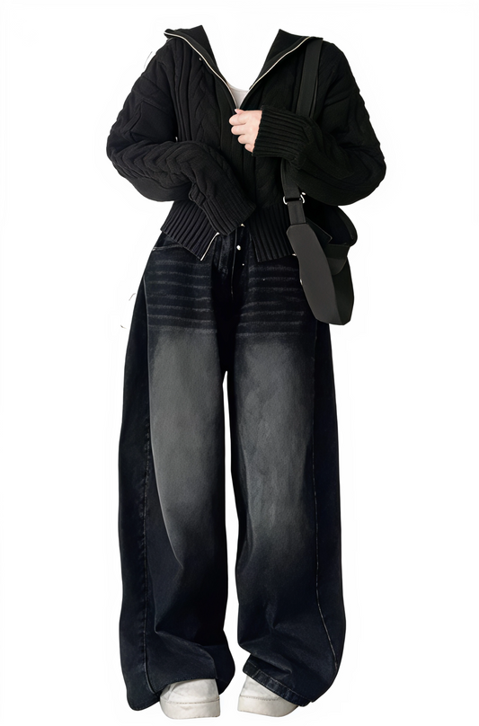 Person wearing a black outfit with wide-leg jeans and a black jacket on a white background