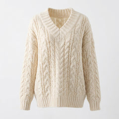 Beige cable knit sweater on a light gray background