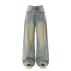 Wide-leg light blue denim jeans with a faded yellowish wash on the front, shown on a plain white background.