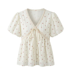 White blouse with floral pattern on a white background