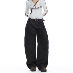 Person wearing a white jacket with text and black wide-leg pants on a white background