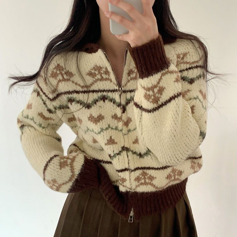 Person wearing a patterned sweater with a neutral background