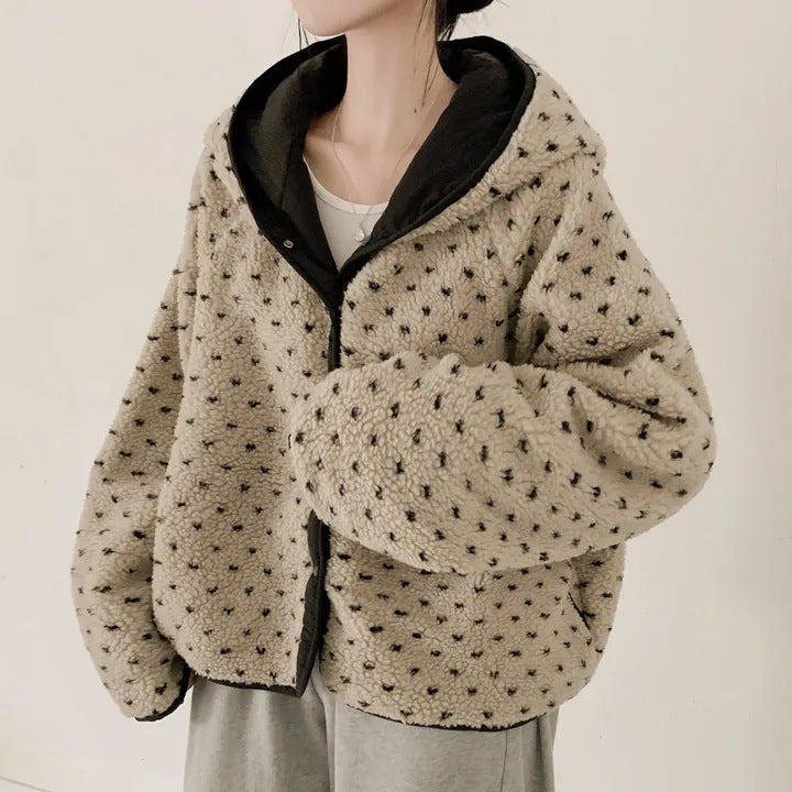 Beige fleece jacket with black pattern on a neutral background