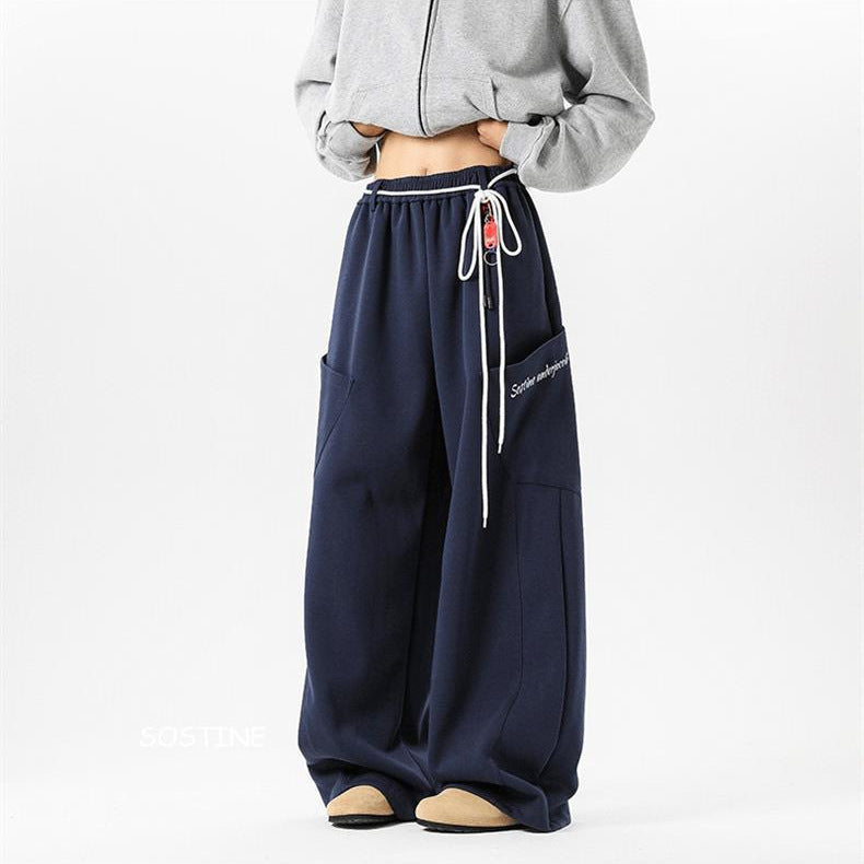 Navy blue sweatpants with white drawstring on a white background
