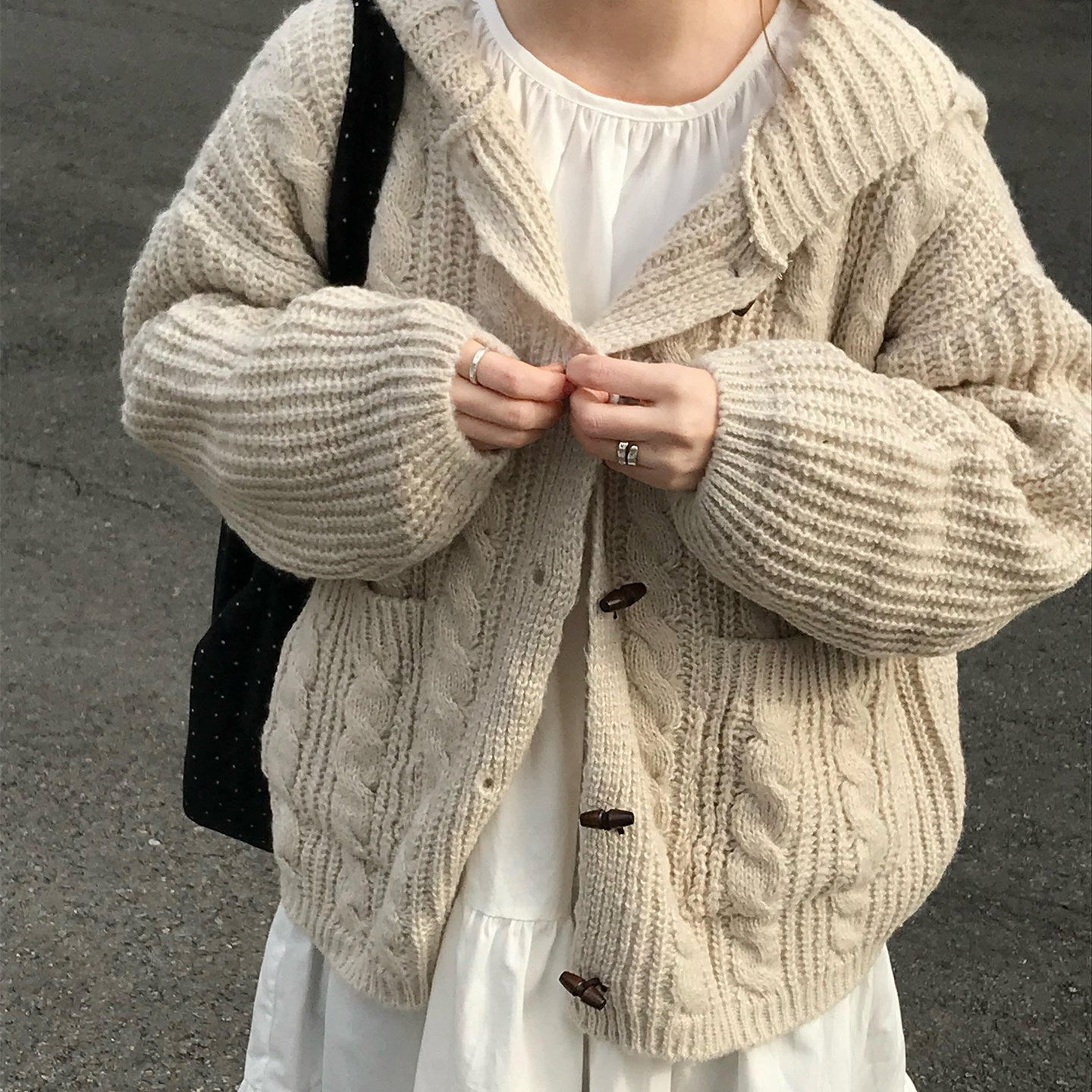 Oversized hooded cable knit cardigan in beige (Mi Xing), front view
